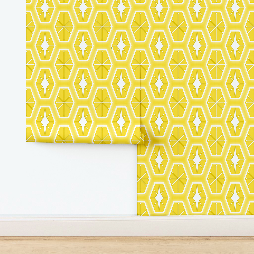 The artwork consists of a repeating geometric pattern featuring hexagonal shapes filled with two different designs. One design inside the hexagons includes a symmetrical starburst or asterisk-like figure with lines radiating from a central point, each line ending in a small circle. The other design features a white diamond shape with extended pointed ends within the yellow hexagon. These hexagons are outlined with a white border and set against a soft yellow background creating a vibrant, retro aesthetic. The use of yellow, white colors, along with the symmetrical arrangement, gives the pattern a mid-century modern, playful style.